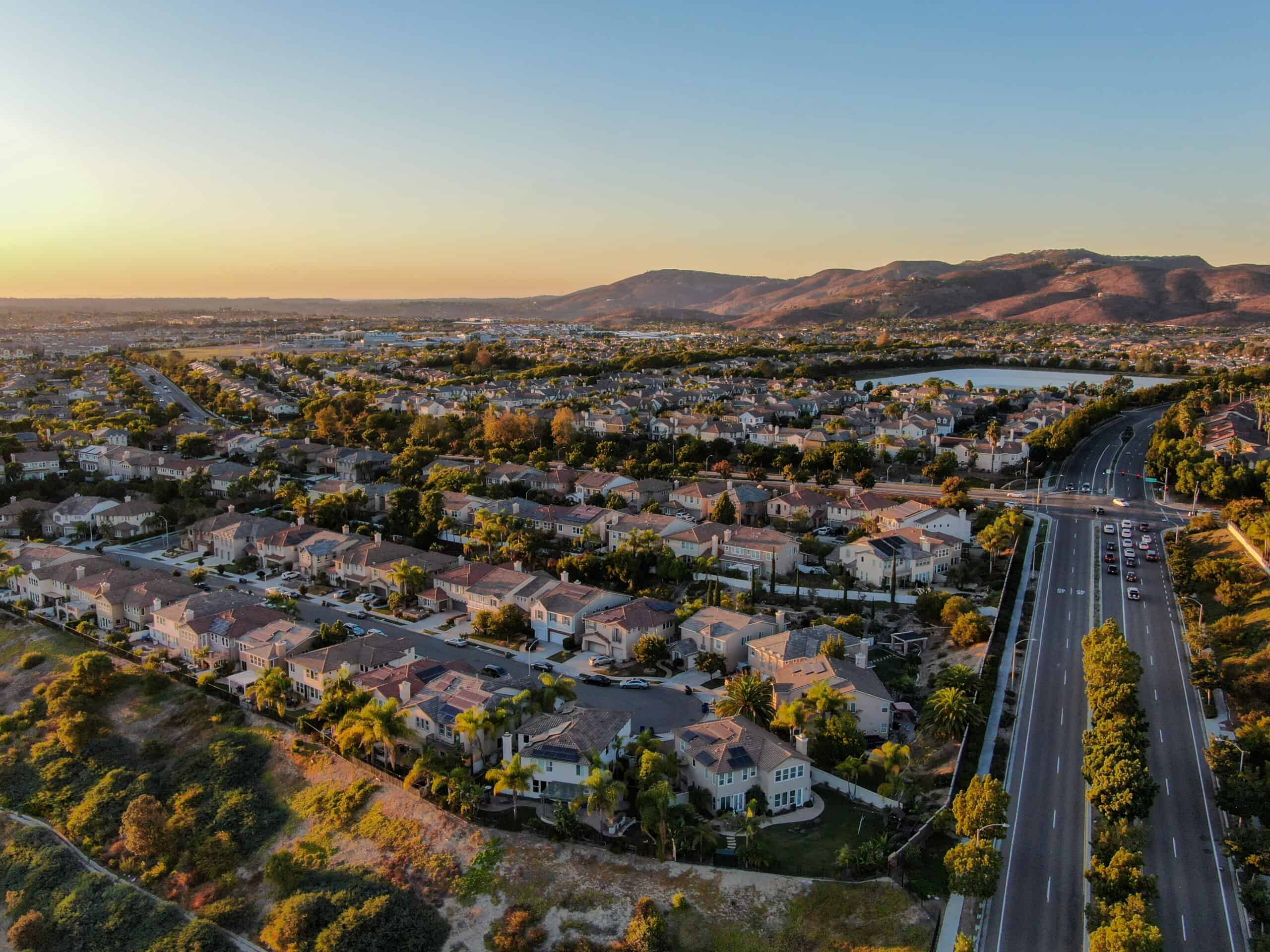 residential-modern-subdivision-house-neighborhood-with-mountain-background-during-sunset-scaled-1